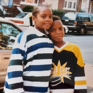 A childhood photo of Lyris Ethel Mattis with her brother, our Founder, on a Brooklyn street in the 1990s.